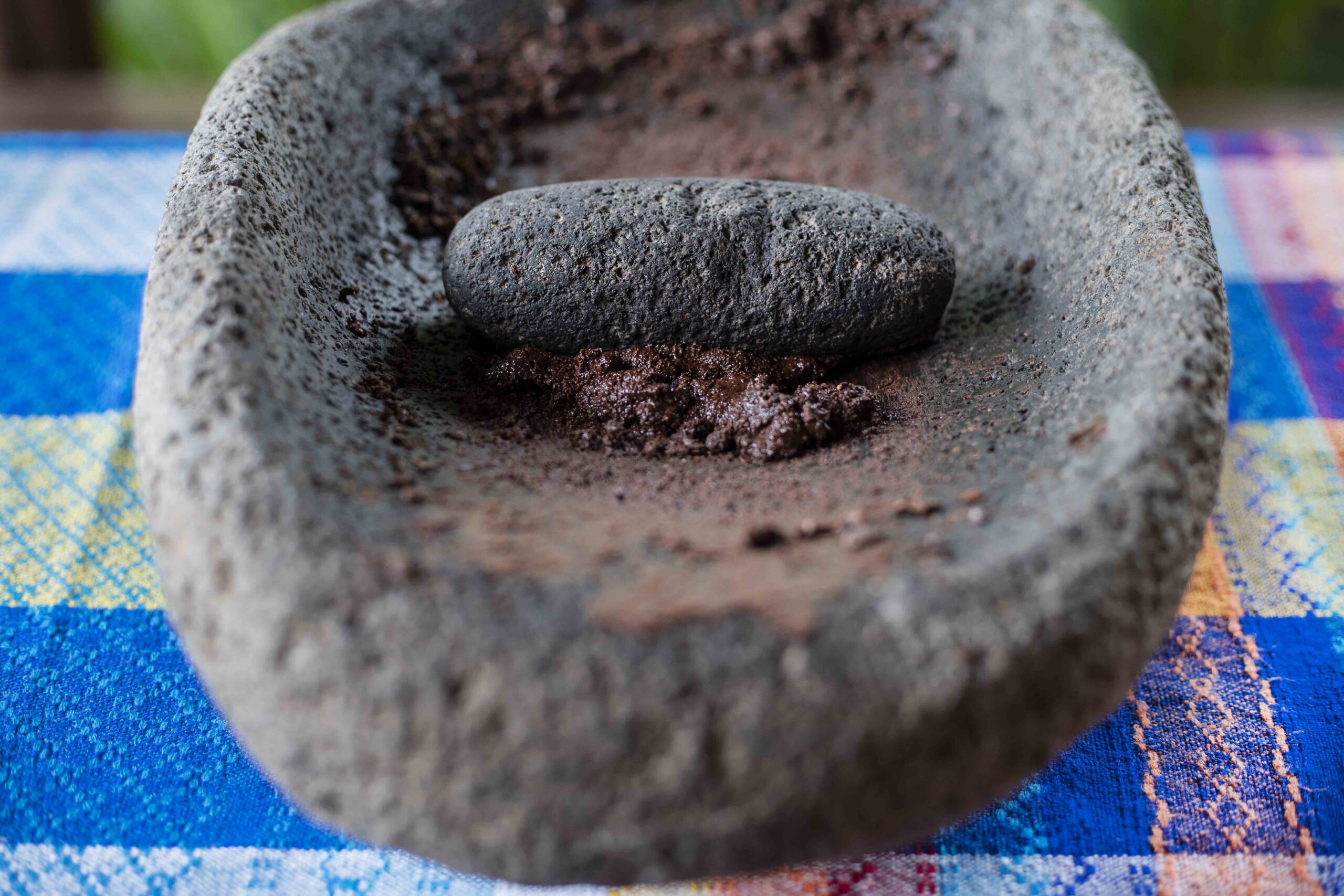 Ancient carved volcanic stone metate used for hand-grinding roasted cacao