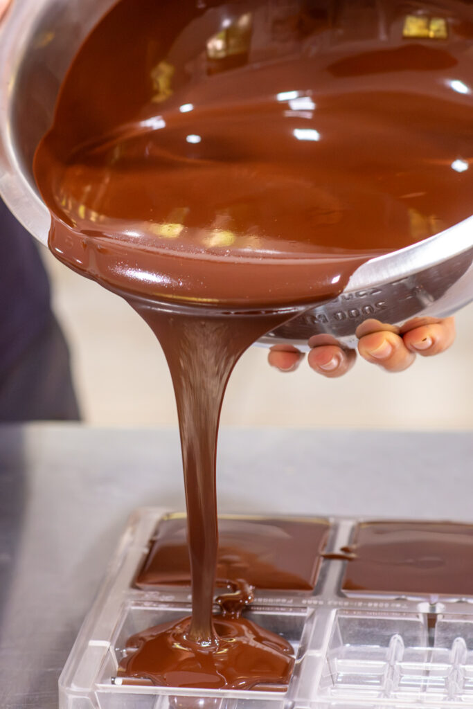 Melted chocolate being poured in the factory