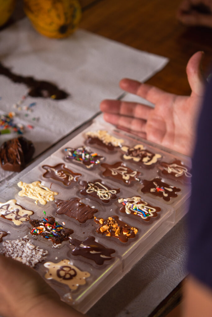 Fresh chocolate being placed into molds