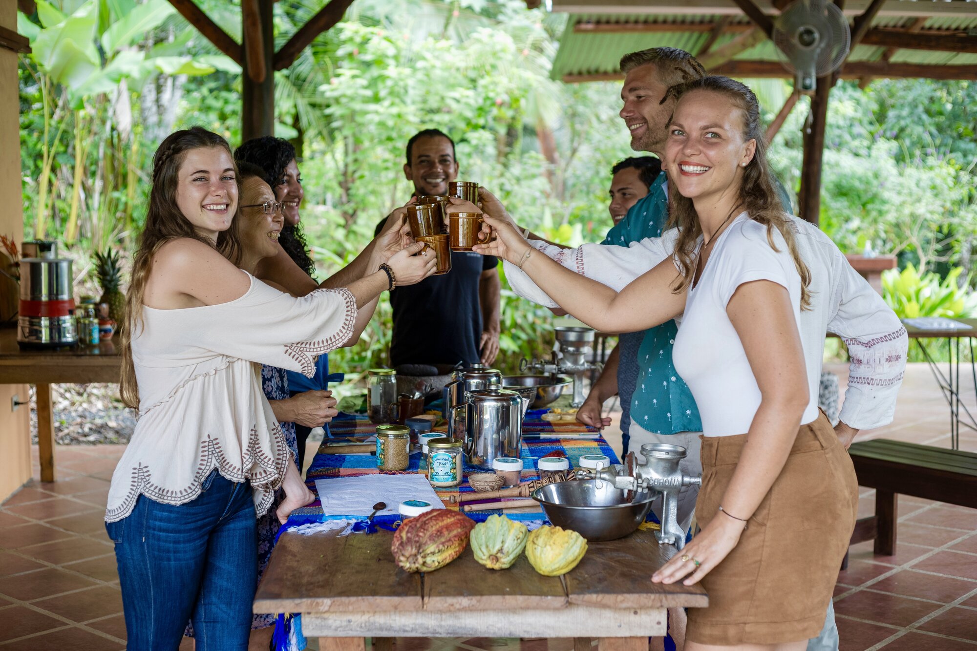 Guests and their guide toast with fresh sugarcane juice during the tour