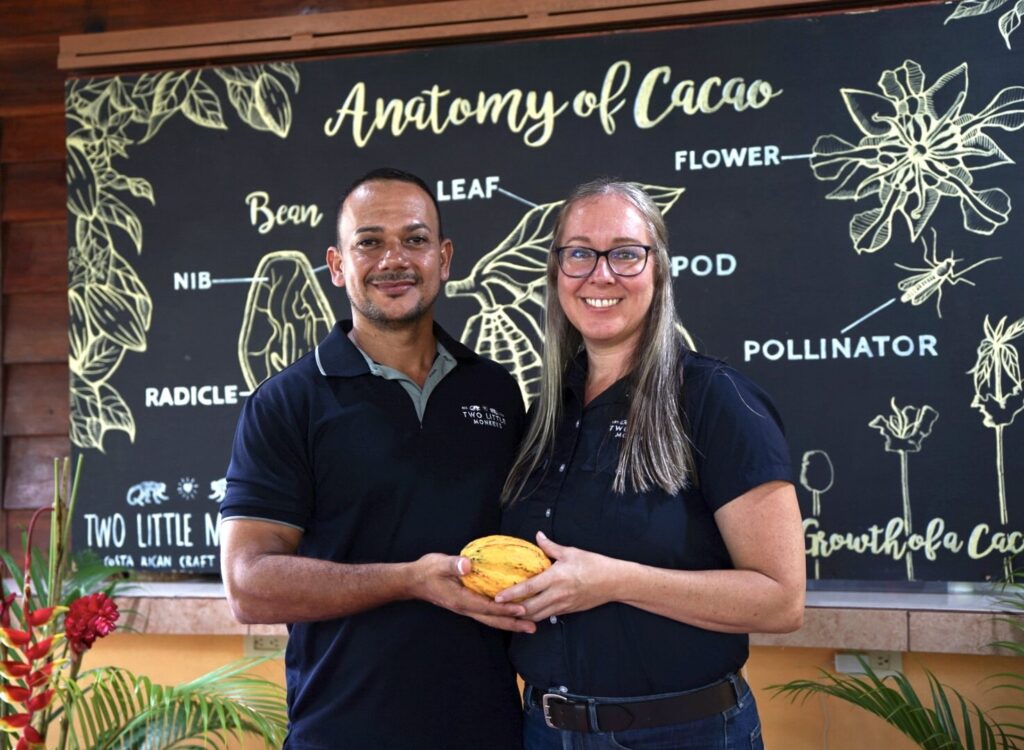 Ismael and Lindy welcoming guests with a fresh cacao pod